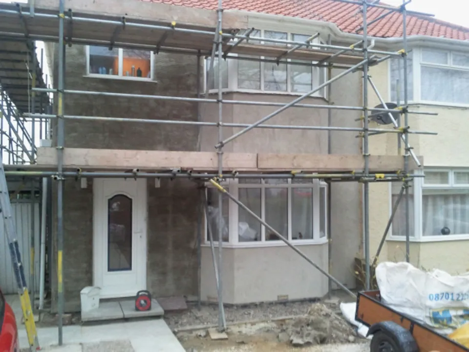 Semi-detached house mid-render with the garden kept clear, Surrey