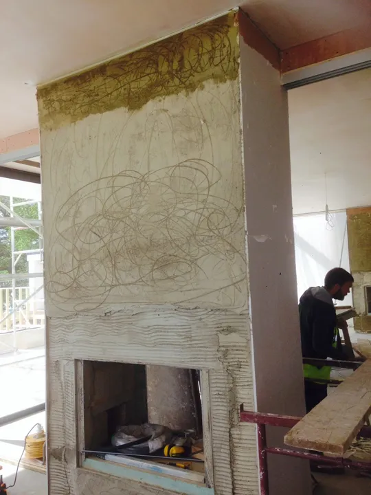 Fireplace opening and chimney breast being plastered, Dorking