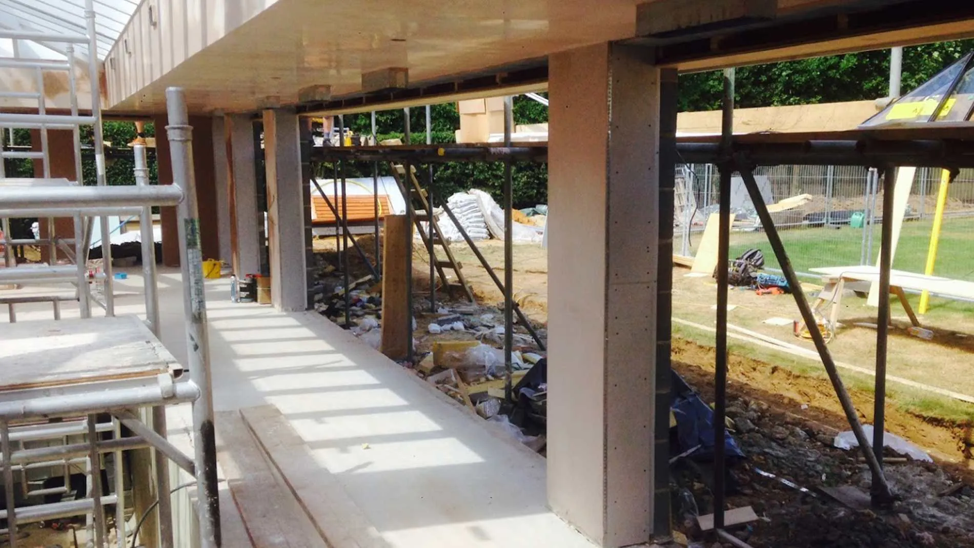 Interior colonnade and beams plastered during an extension build, Surrey