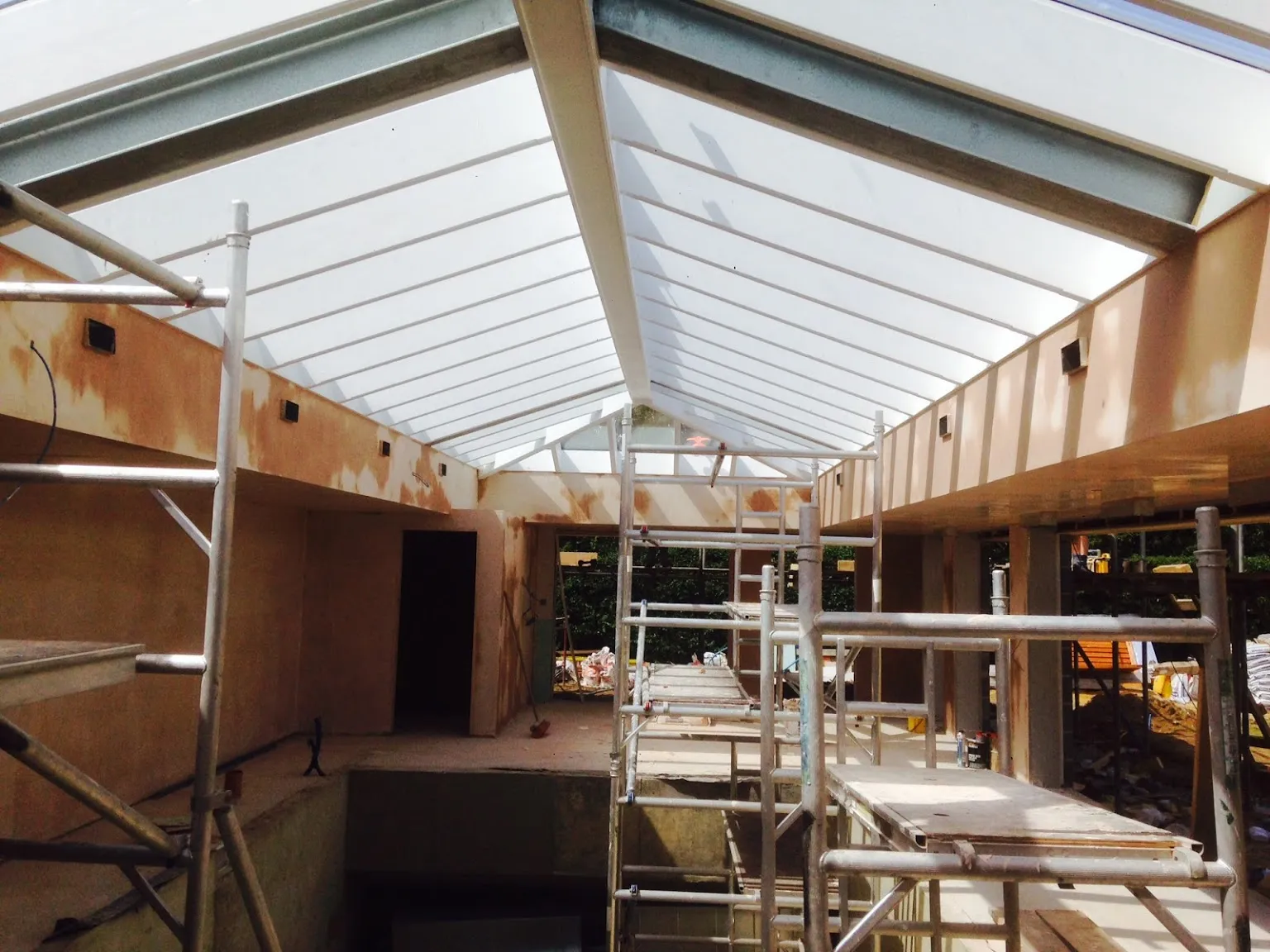Orangery extension with plastered walls beneath a new pitched roof, Dorking