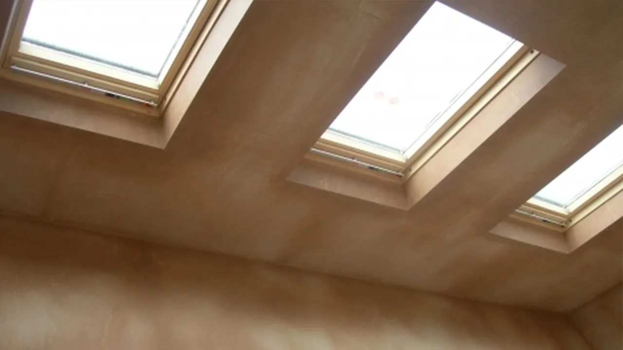 Loft conversion ceiling and Velux window reveals plastered by A.I. Myles Plastering Service