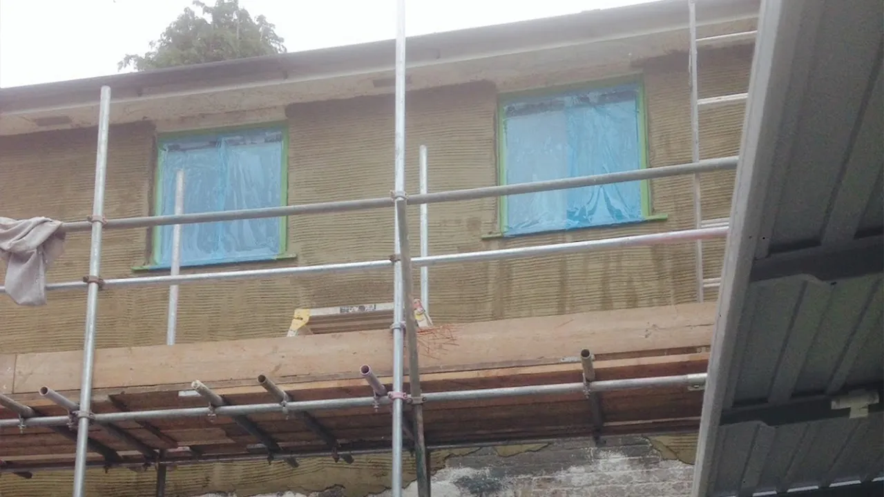 House being rendered with the windows masked up for protection, Dorking